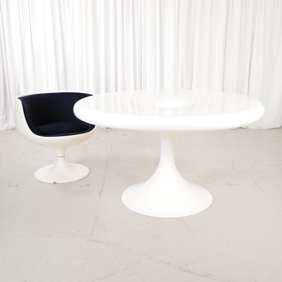 White Eero Aarnio Kanttarelli dining table for Asko, styled with a chair that is not included