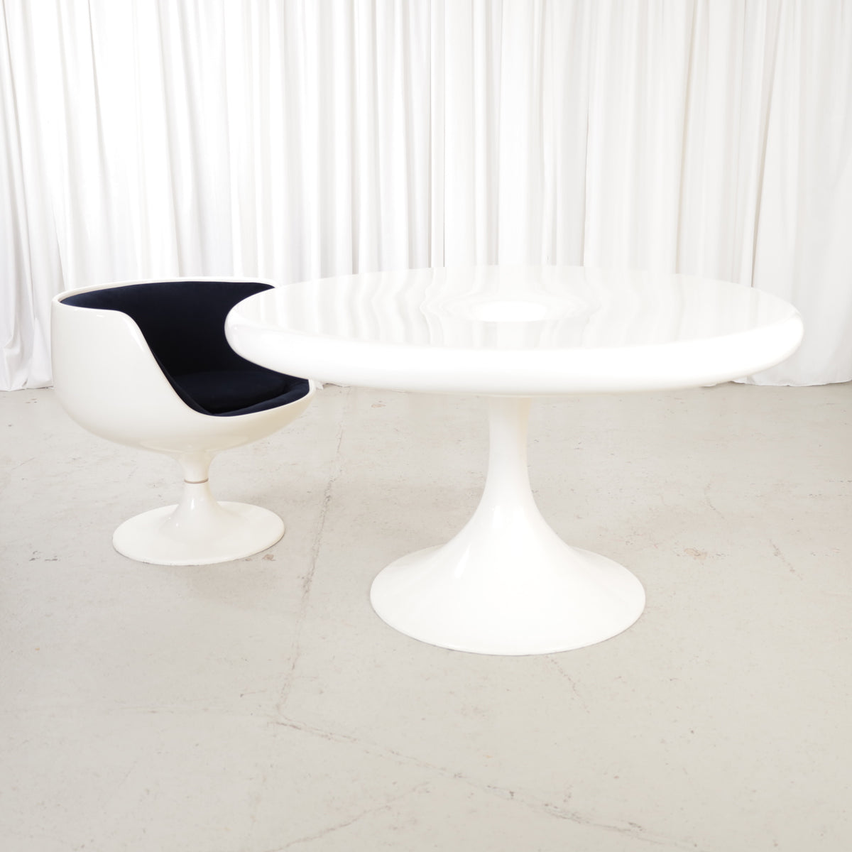 White Eero Aarnio Kanttarelli dining table for Asko, styled with a chair that is not included