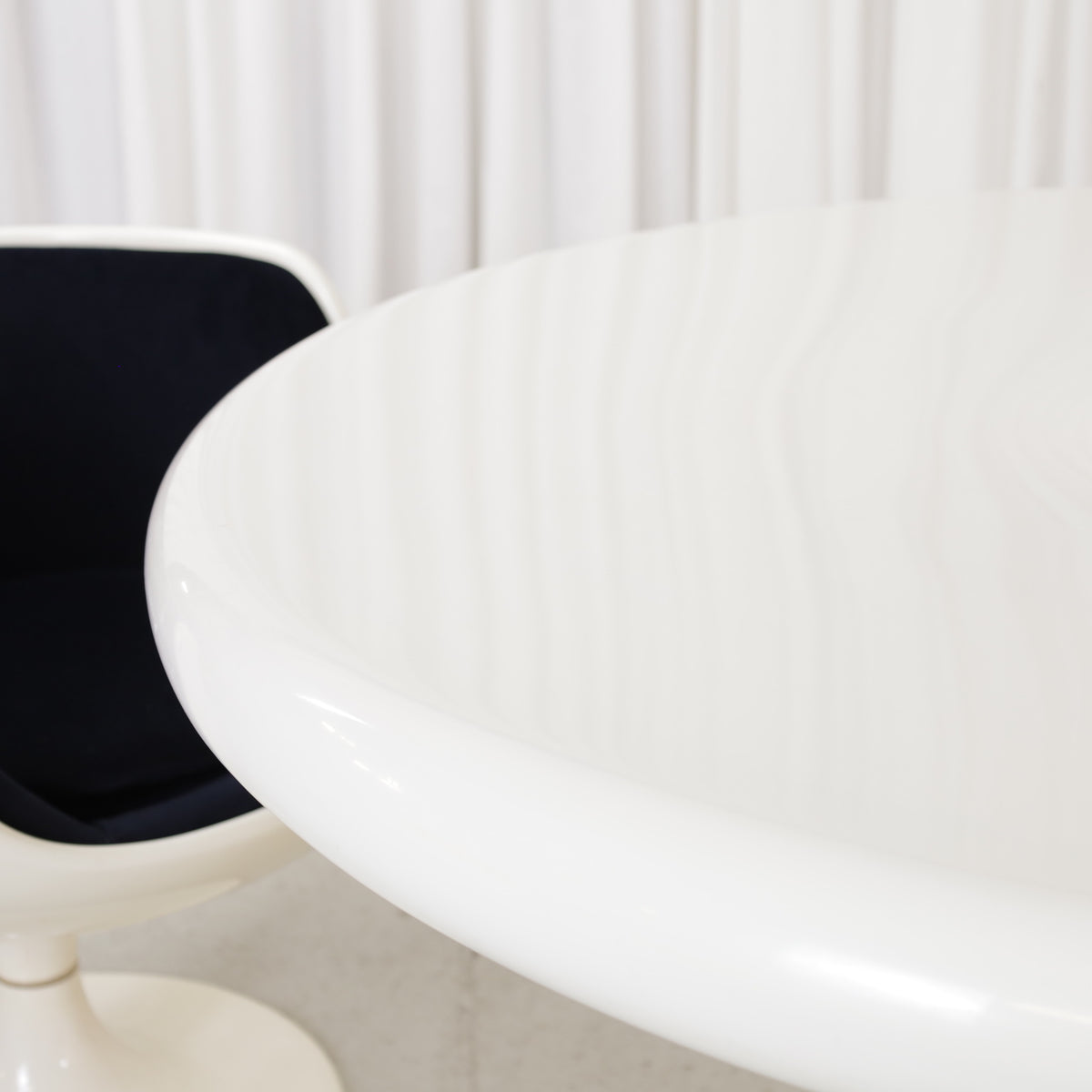 White Eero Aarnio Kanttarelli dining table for Asko, styled with a chair that is not included