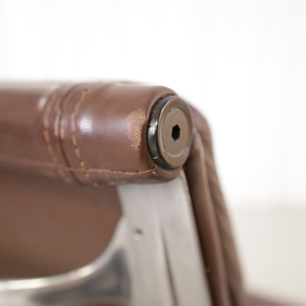 Backrest frame joint and brown leather upholstery