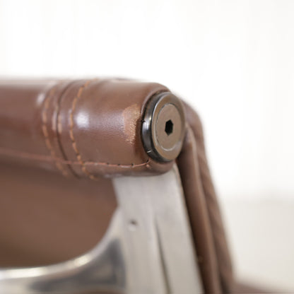 Backrest frame joint and brown leather upholstery