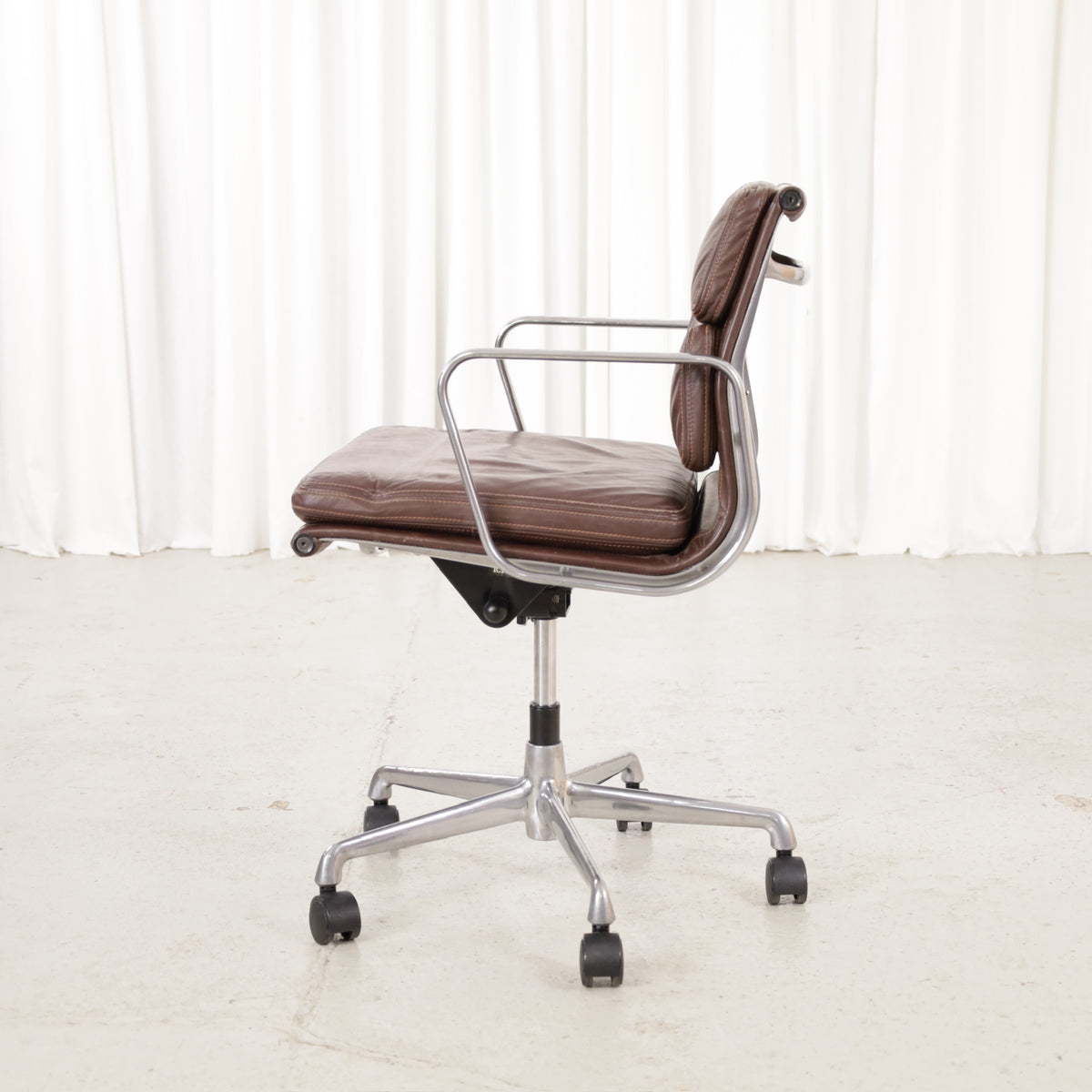 Side view of the second brown leather office chair