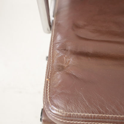 Brown leather seat showing creasing and indentations