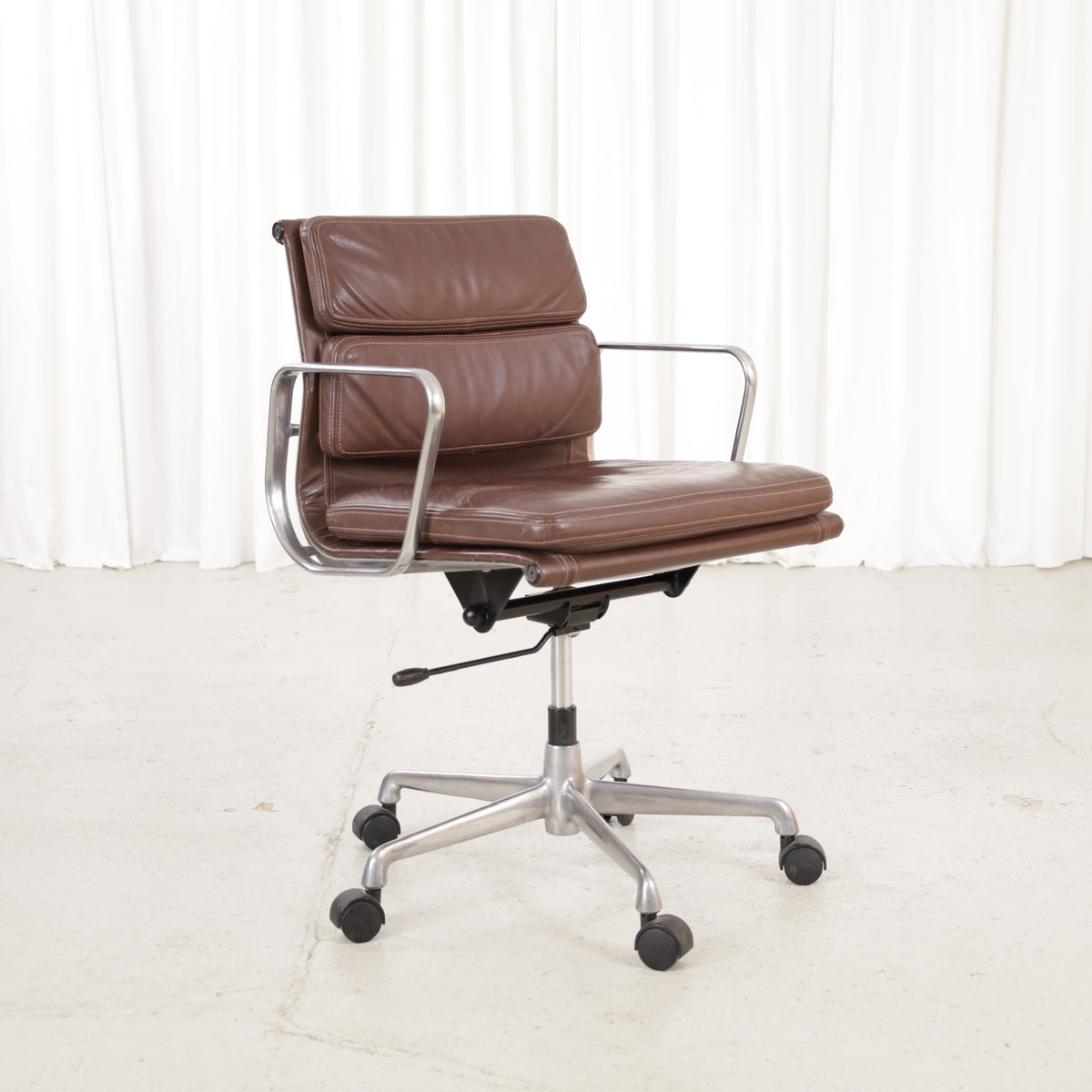 Front angled view of the brown leather Soft Pad chair