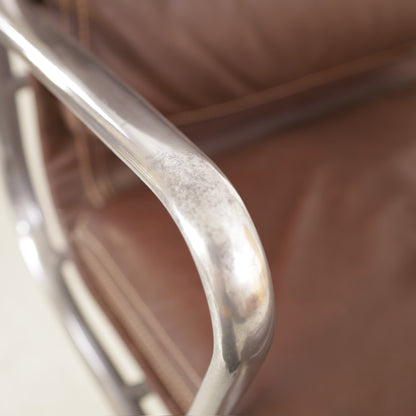 Polished metal armrest showing minor surface marks
