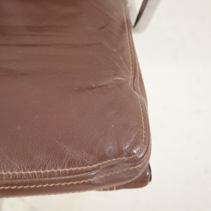Brown leather seat upholstery and stitching detail