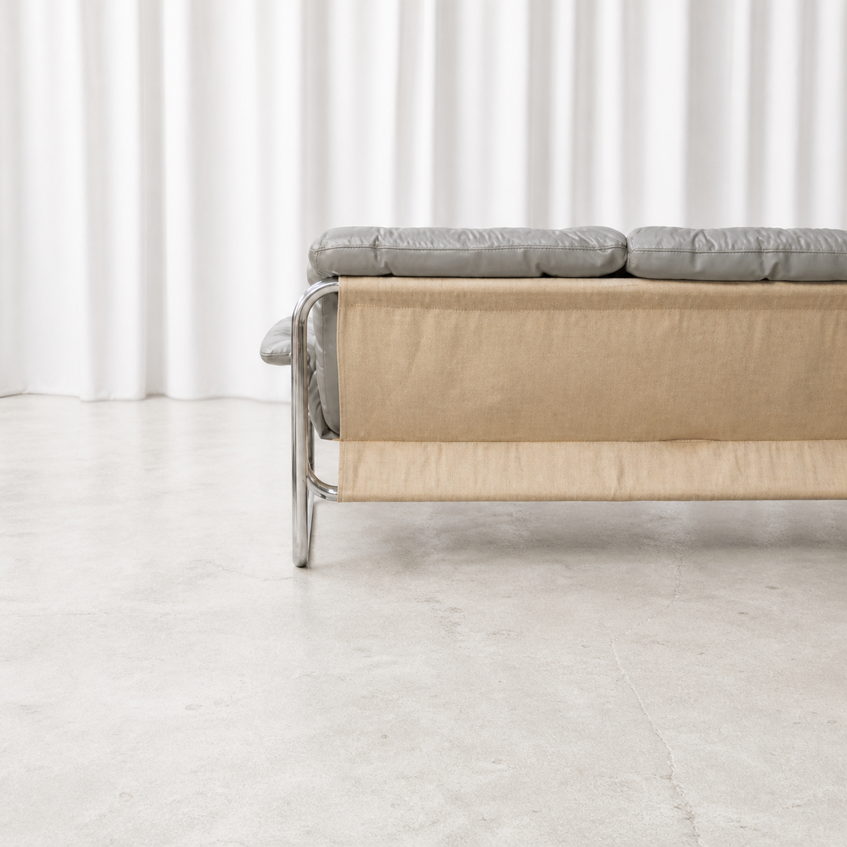 Close rear view of the beige supporting canvas and chrome frame