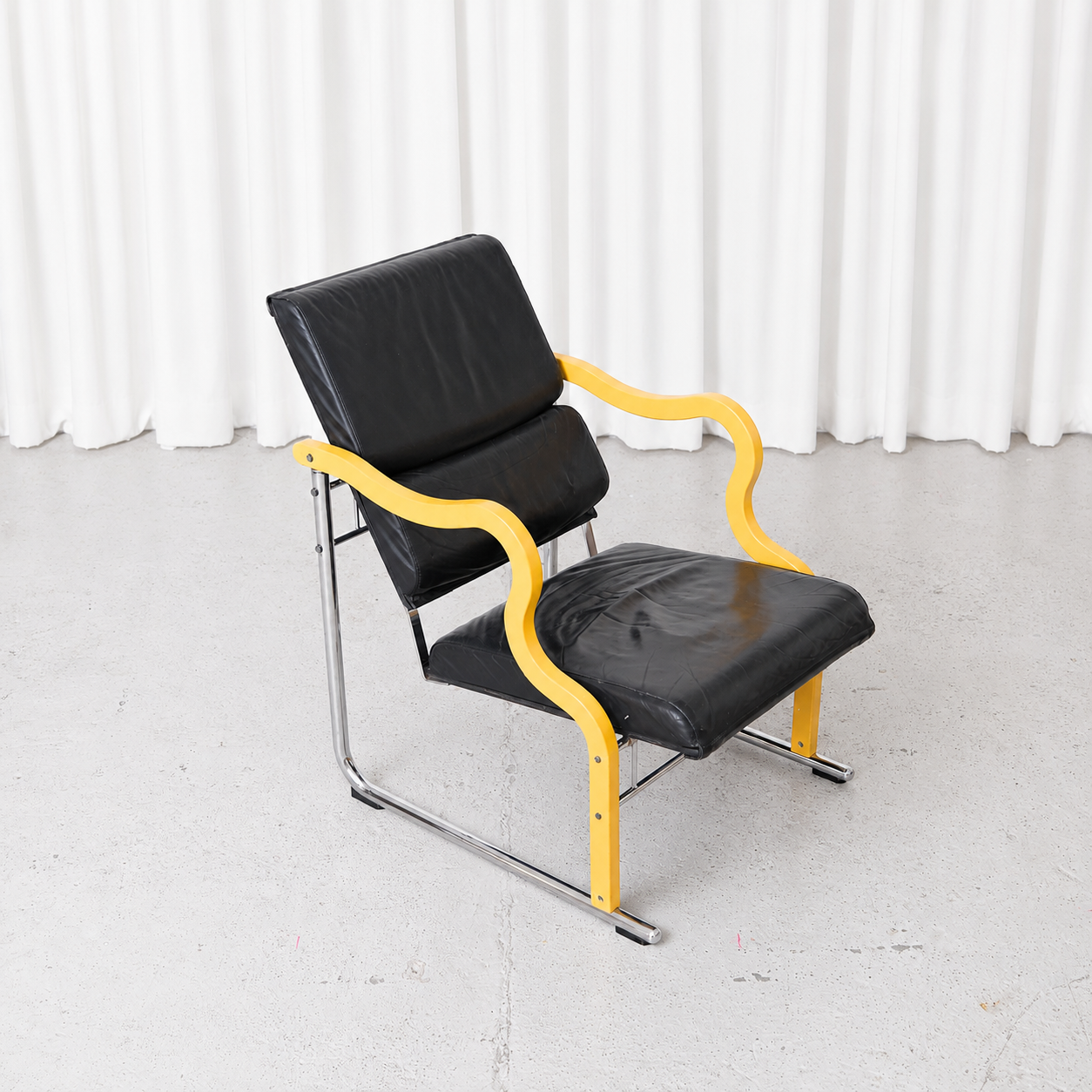 Yrjö Kukkapuro Experiment Lounge Chair in Black Leather and Yellow Armrests