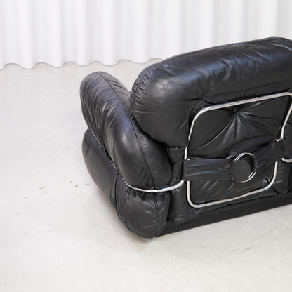Rear detail of the black leather upholstery and chrome-steel frame of the Isku Hannibal sofa.