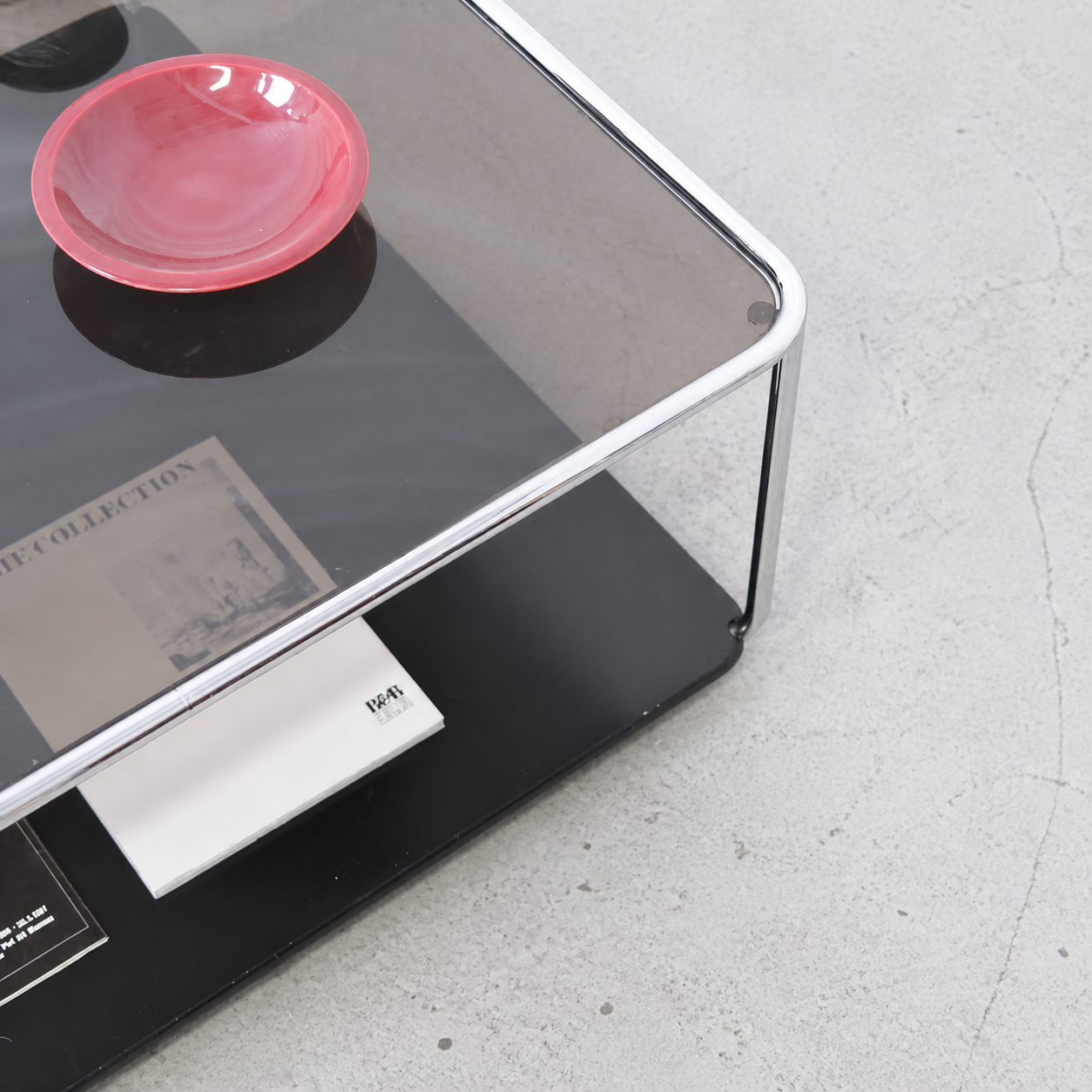 Rounded chrome frame and dark tinted glass top detail