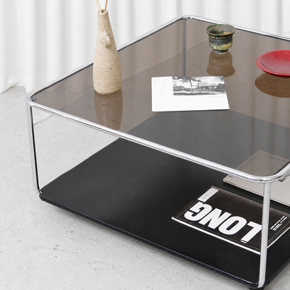 Dark tinted glass top and black lacquered lower shelf detail