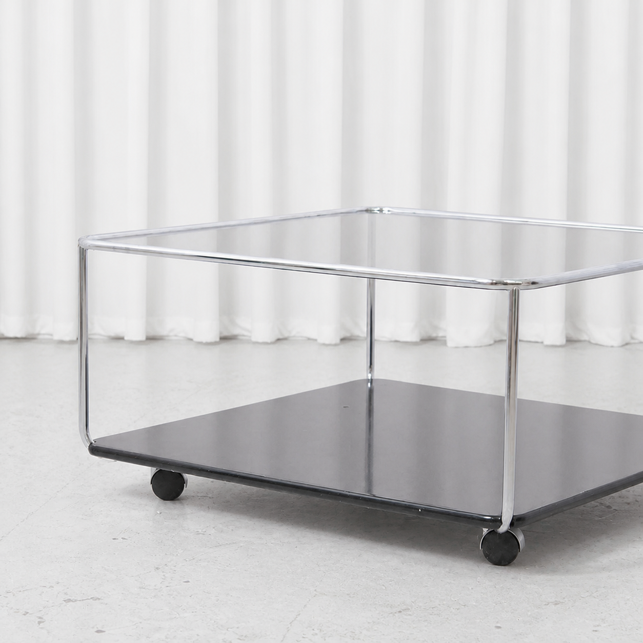 Chrome frame, smoked glass top and black lower shelf of Hannibal coffee table