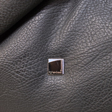 Ligne Roset maker's badge on the black upholstery of the Togo sofa.