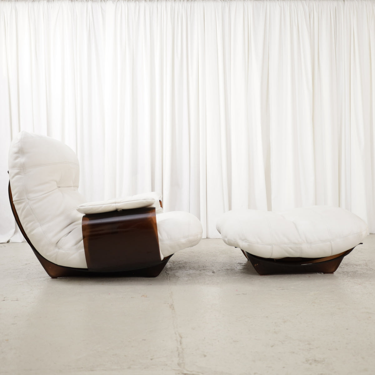Michel Ducaroy Marsala lounge chair and ottoman for Ligne Roset, side view of white leather and dark curved frames