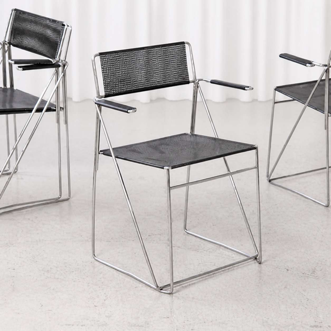 Niels Jørgen Haugesen X-Line armchair with black perforated steel and chrome frame