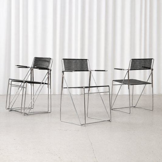 Four Niels Jørgen Haugesen X-Line armchairs in black and chrome