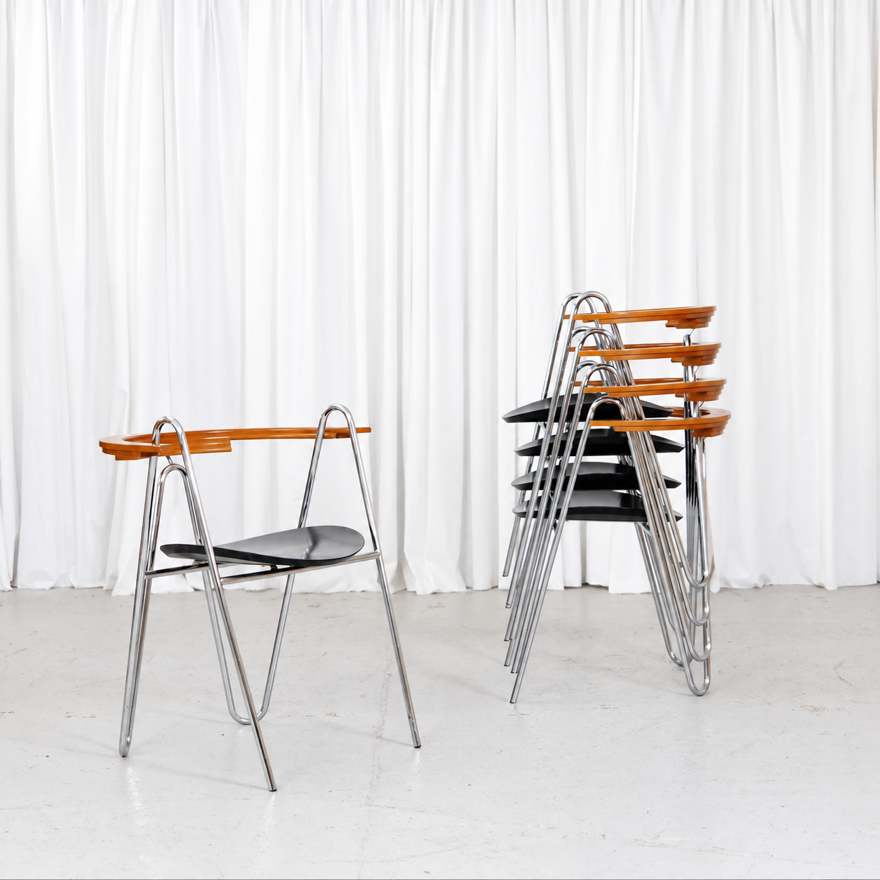Five Pentti Hakala W chairs shown stacked beside one chair