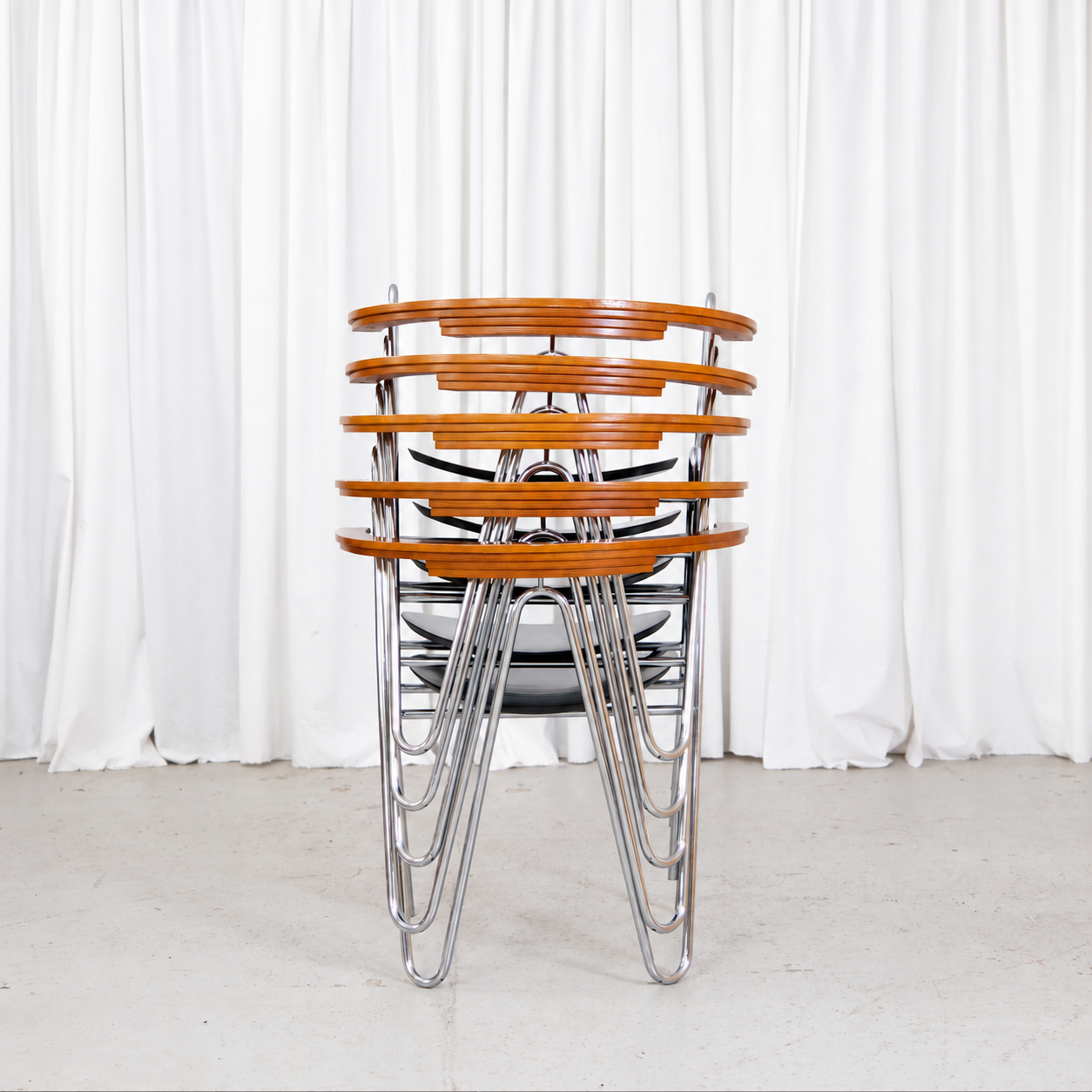 Rear view of five stacked Pentti Hakala W chairs