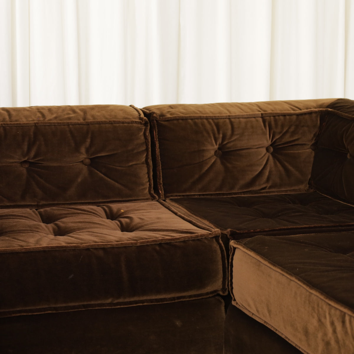 Corner seating and buttoned brown velvet cushions