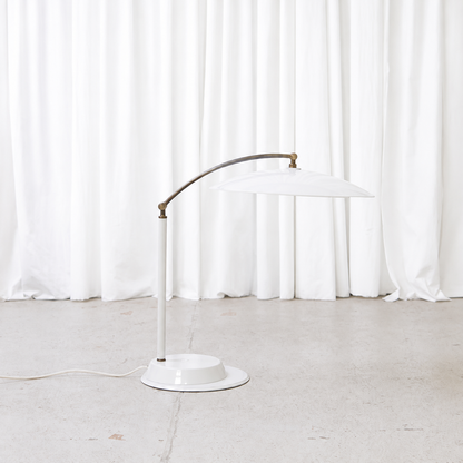Side view of vintage adjustable white table lamp
