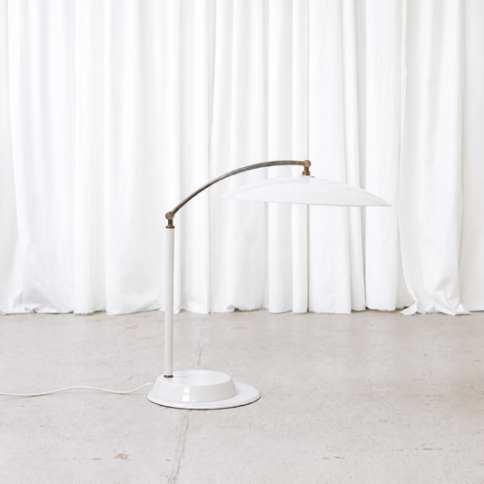 Side view of vintage adjustable white table lamp