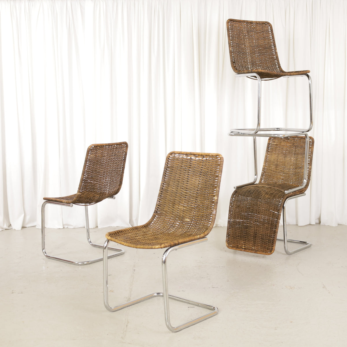 Five vintage Italian cantilever chairs with chrome frames and rattan together