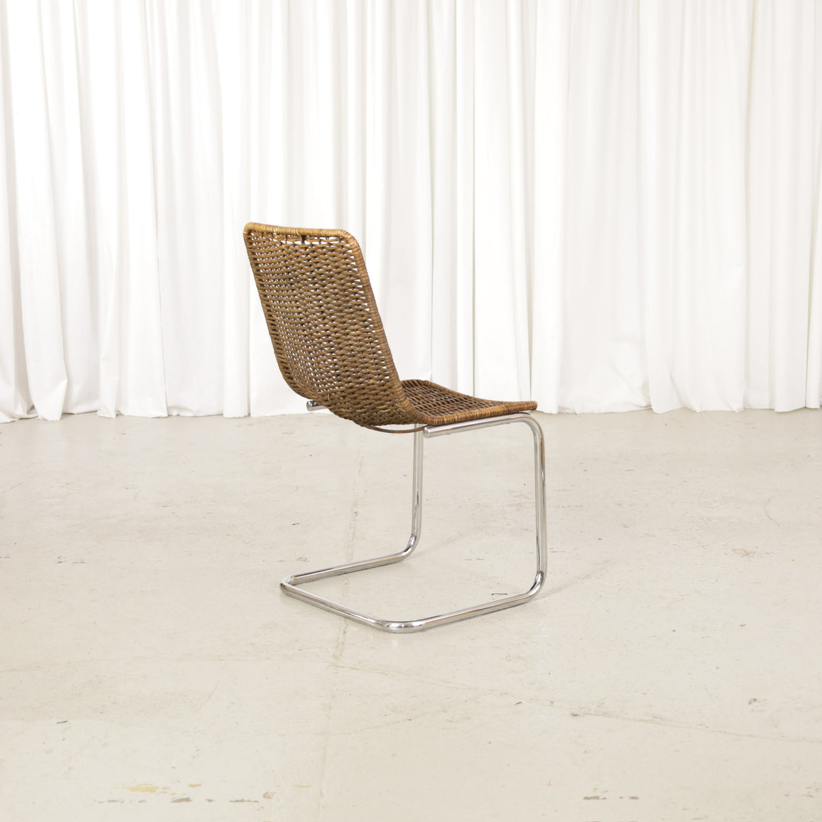 Vintage Italian Chrome and Rattan Cantilever Chair, vintage Italian chrome and rattan chair, three-quarter view