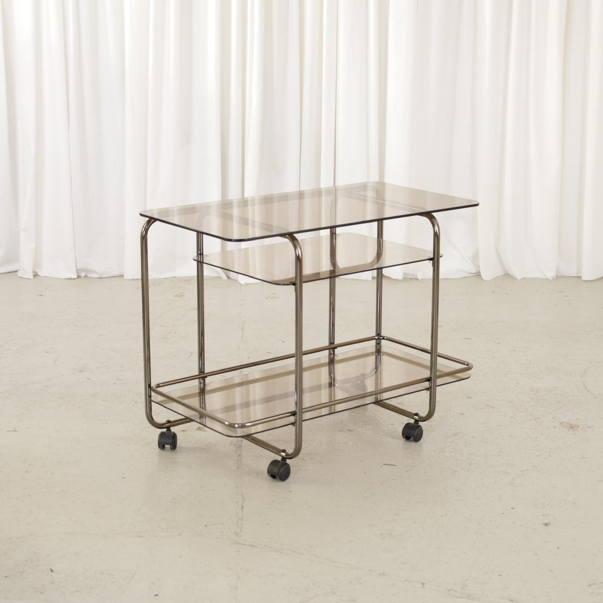 Vintage Italian-style chrome and smoked glass serving trolley, three-quarter view