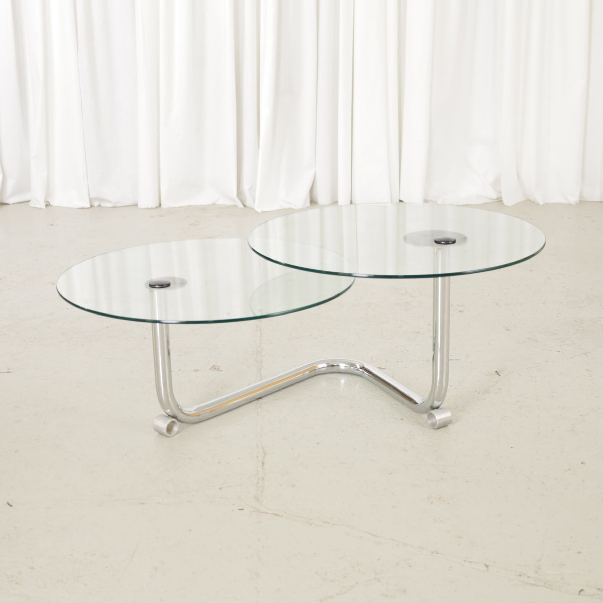 Vintage Italian-style swivel glass coffee table in chrome, three-quarter view