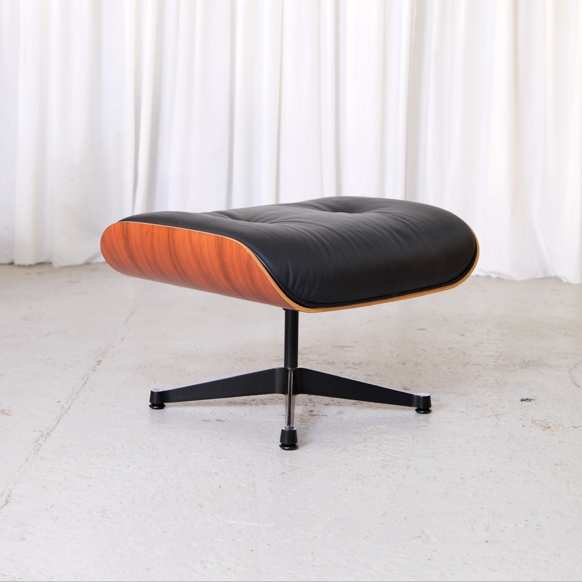 Vitra Eames Ottoman in Santos palisander and black Premium F leather