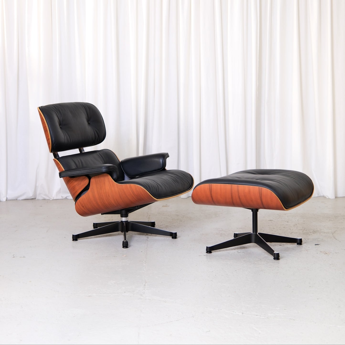 Vitra Eames Lounge Chair and Ottoman in Santos palisander and black leather, front view