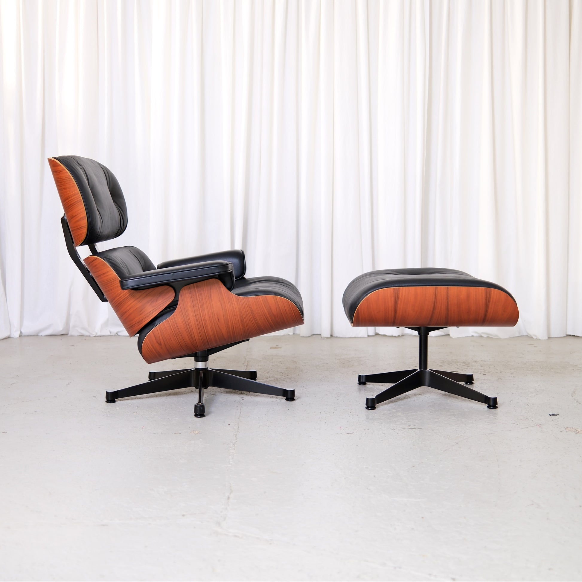 Vitra Eames Lounge Chair and Ottoman in black leather, side view