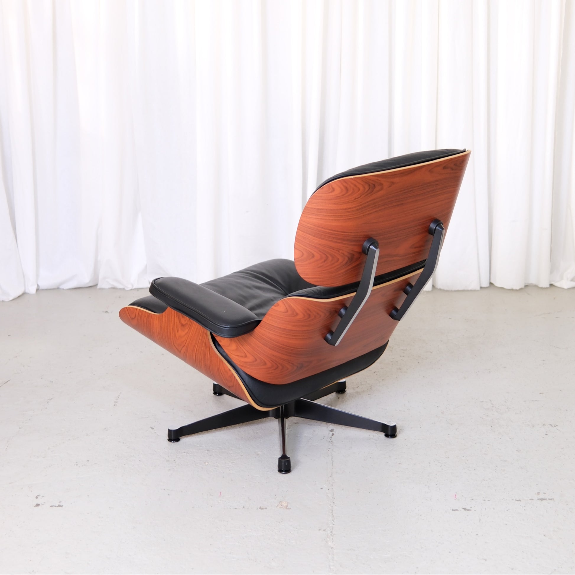 Vitra Eames Lounge Chair with Santos palisander shells, rear three-quarter view