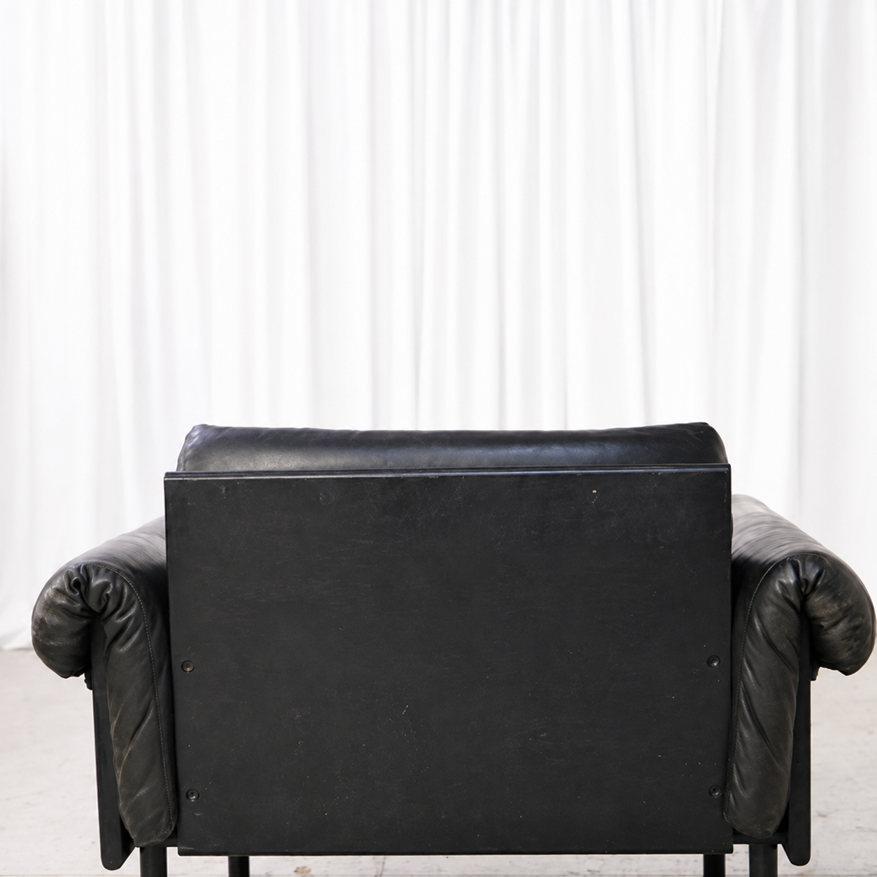 Rear panel and removable headrest brackets on a vintage Ateljee armchair