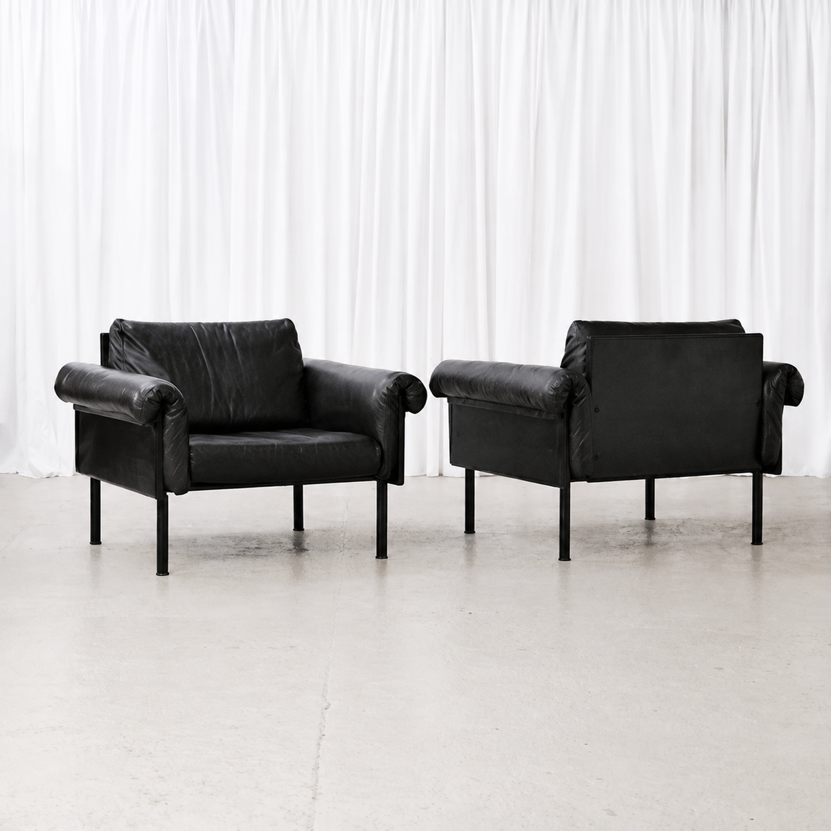 Front and rear views of Yrjö Kukkapuro Ateljee armchairs in black leather