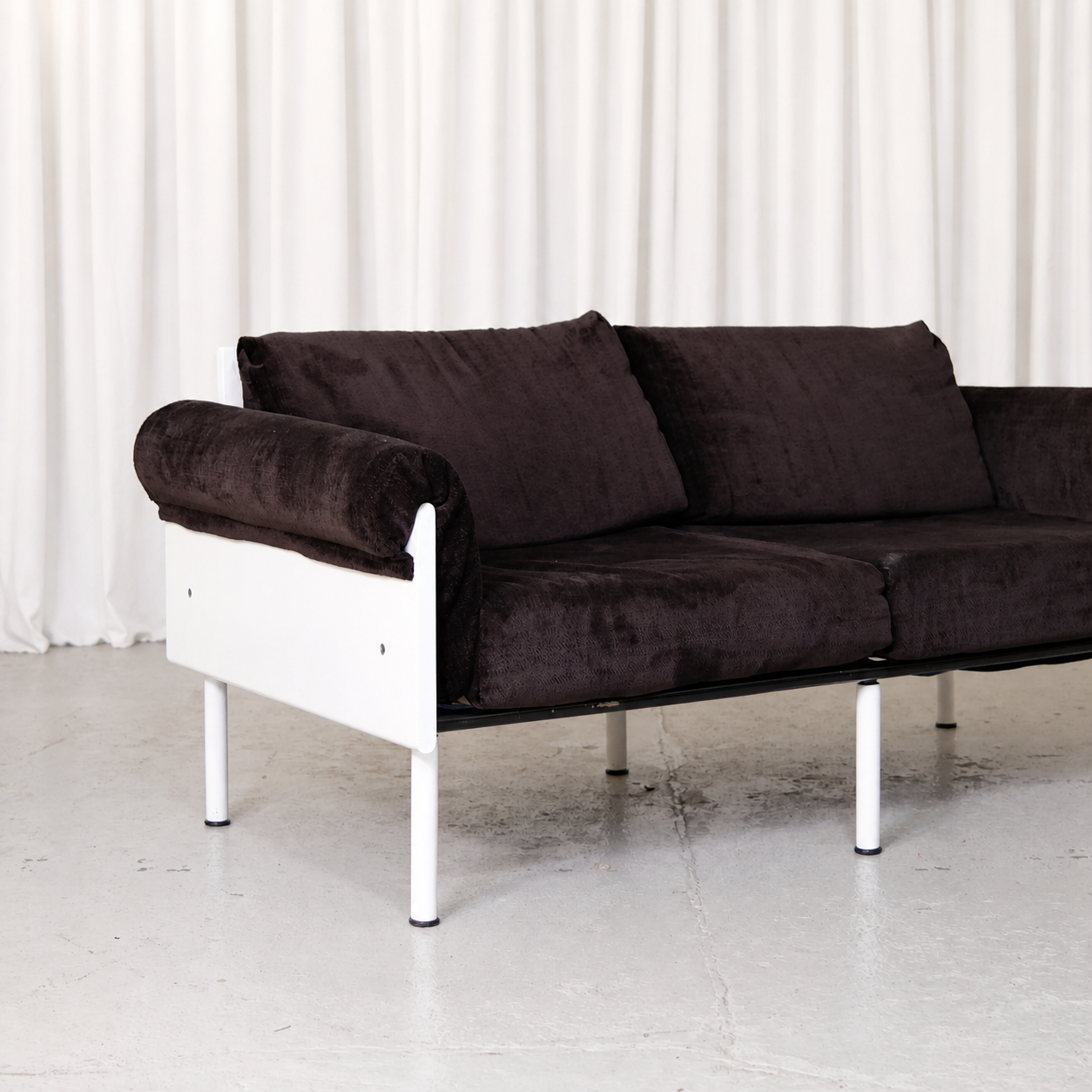 Brown velvet upholstery and white frame of Ateljee sofa