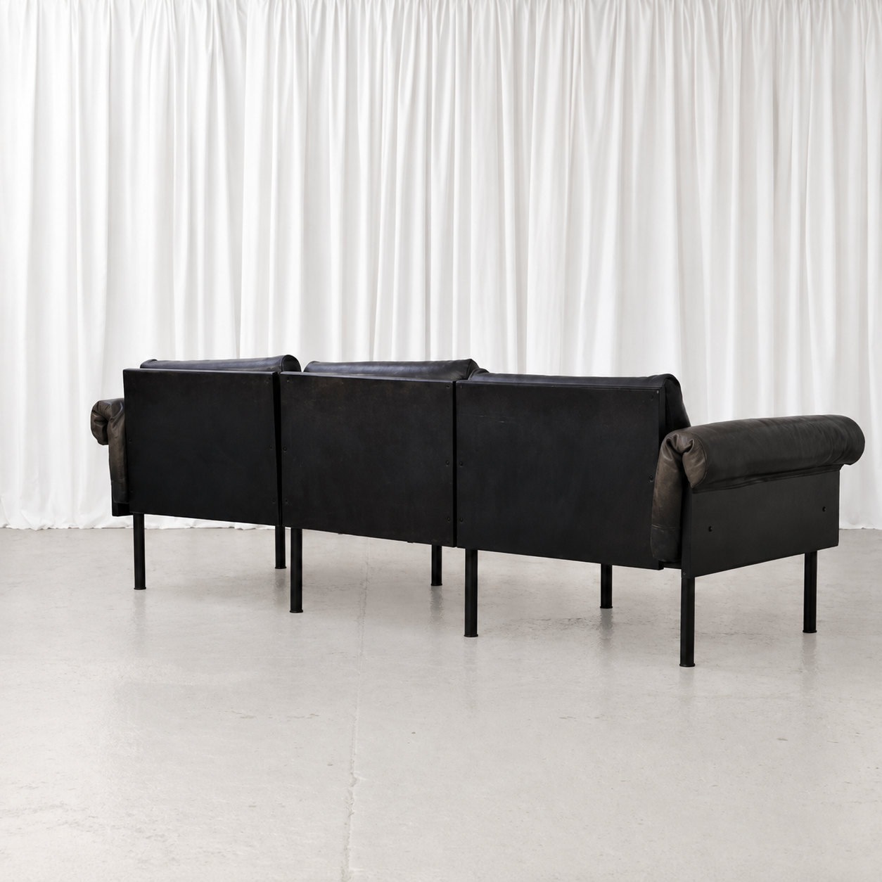 Black wooden rear frame of Yrjö Kukkapuro Ateljee three-seat sofa