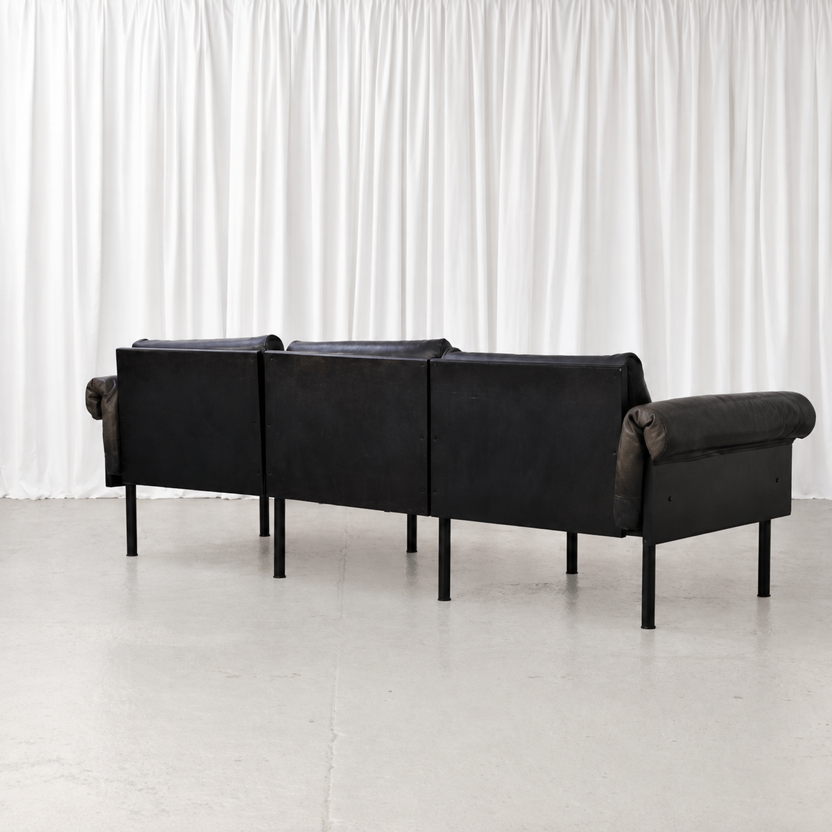 Black wooden rear frame of Yrjö Kukkapuro Ateljee three-seat sofa