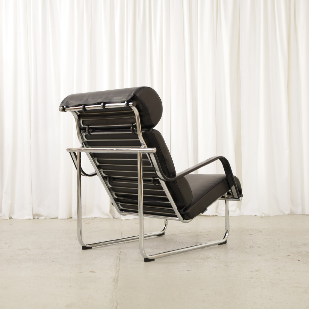 Yrjö Kukkapuro Remmi Lounge Chair with New Black Leather Cover, remmi chair, rear three-quarter view showing metal support straps