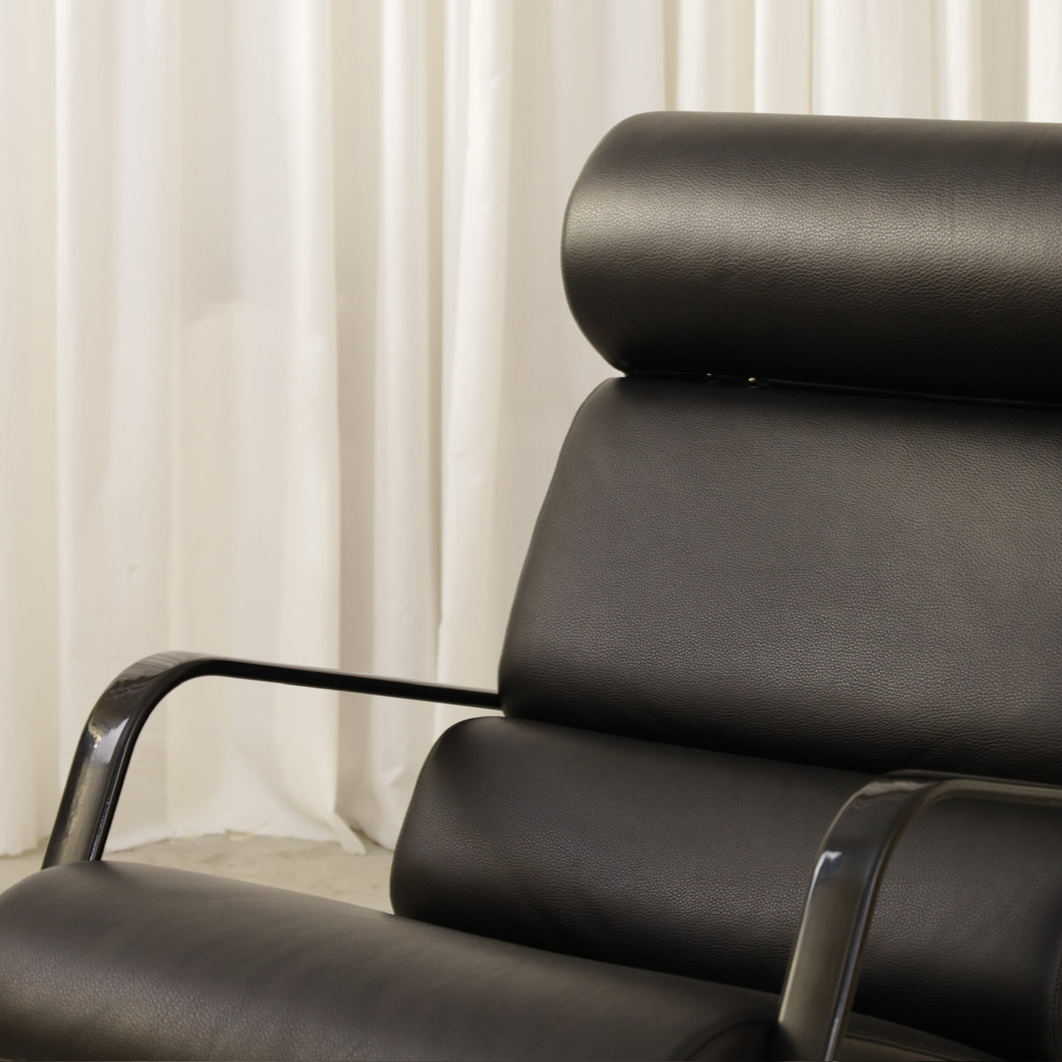 Yrjö Kukkapuro Remmi Lounge Chair with New Black Leather Cover, front detail of the black leather headrest and backrest